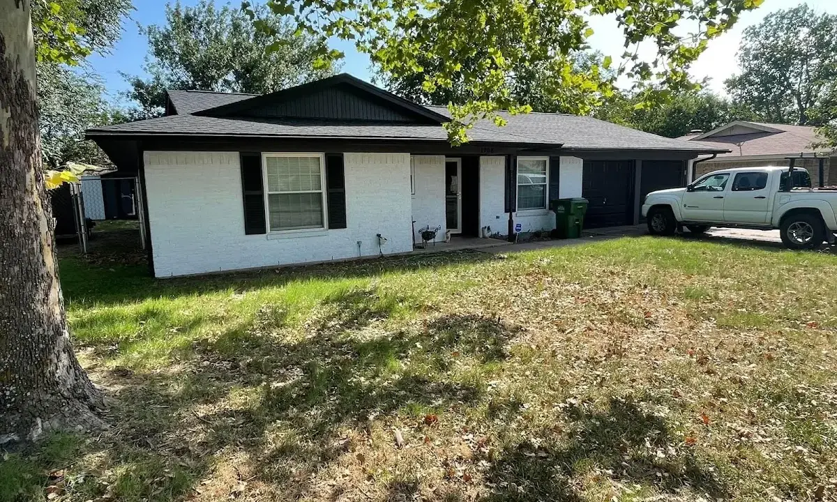Professional roofing crew working on a residential roof in Booneville